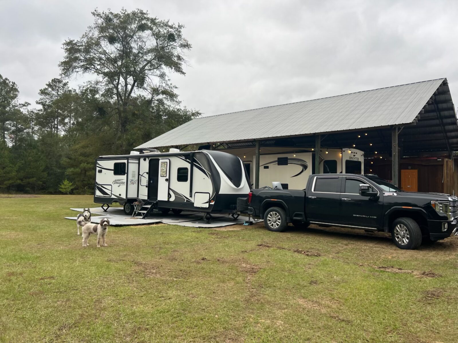 RV on the full hookup pad beside the pole barn